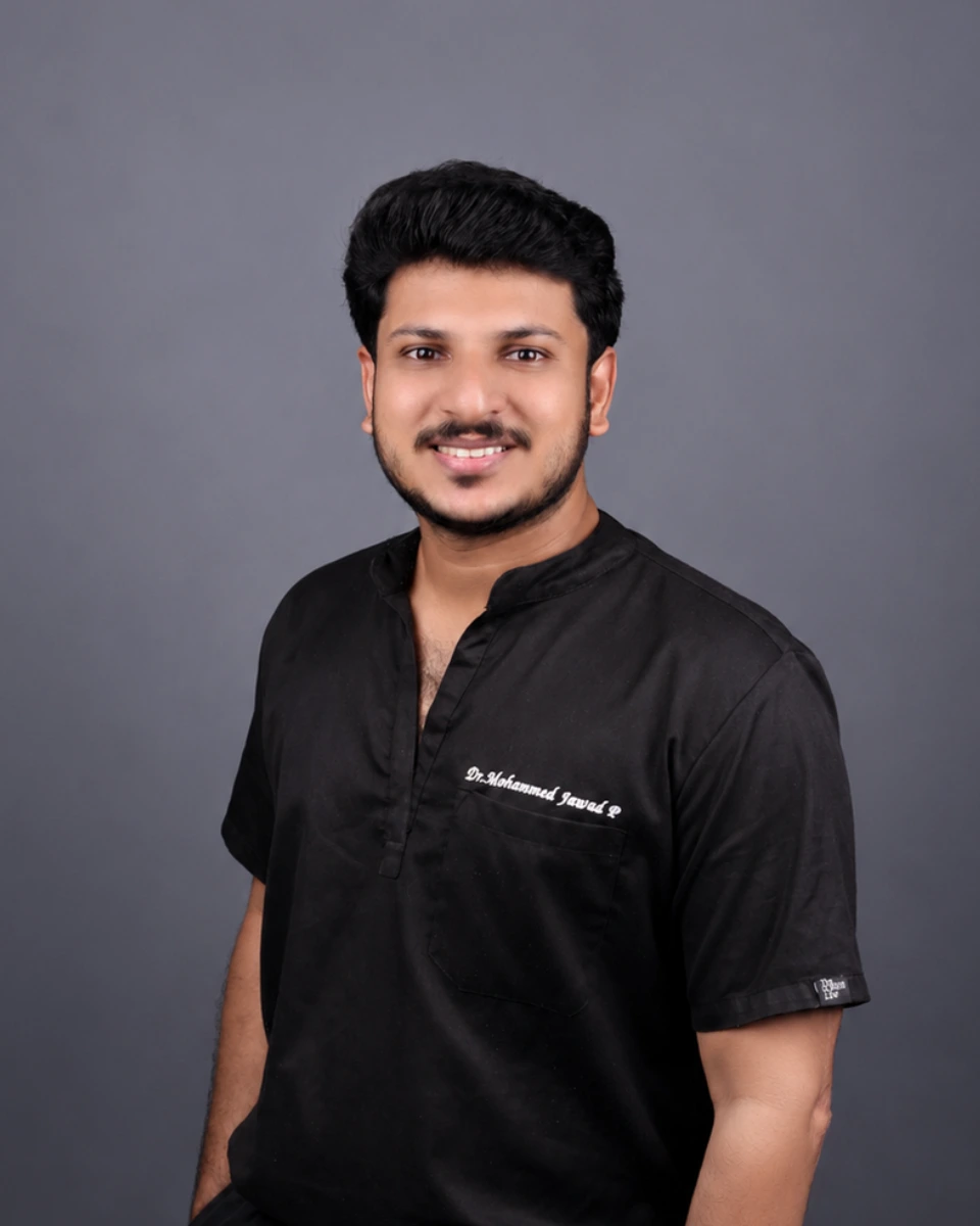 A professional and friendly dentist in a bright, modern clinic environment holding a digital scanning device.